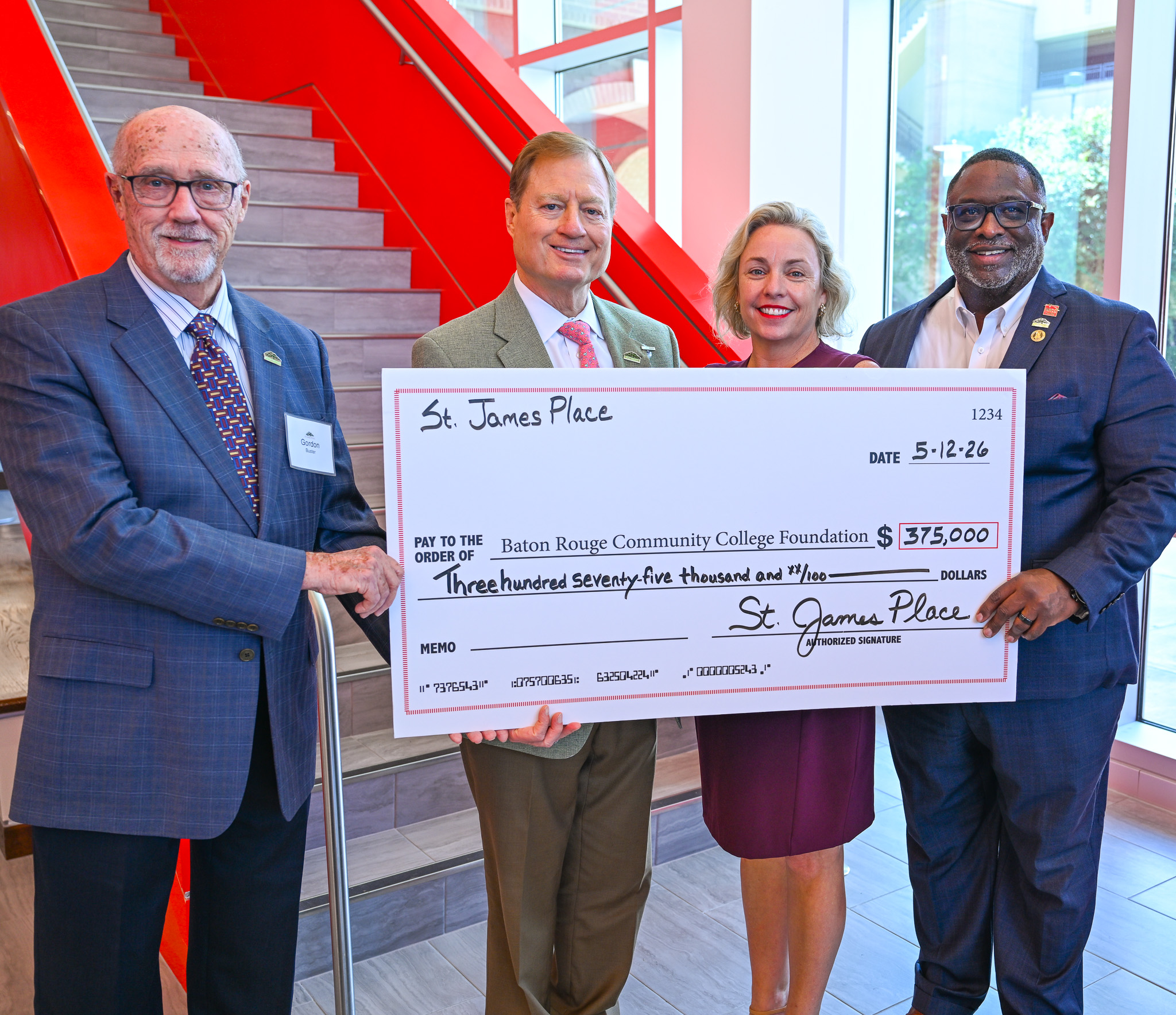 BRCC and St. James Place leadership hold a check